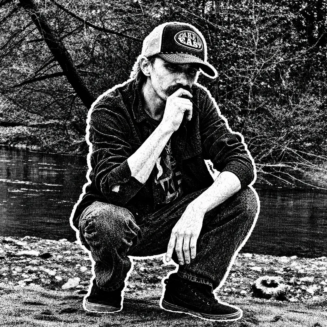 DANMAN seated beside a river